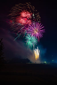 Low angle view of firework display at night