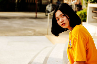 Portrait of beautiful young woman standing outdoors