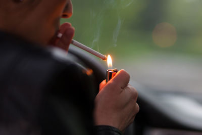 Close-up of man igniting cigarette