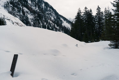 Scenic view of snow covered field and mountains