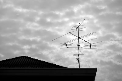 Low angle view of silhouette roof against sky