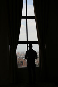 Silhouette of people standing against sea