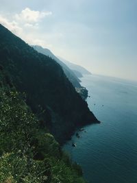 High angle view of sea and mountains against sky