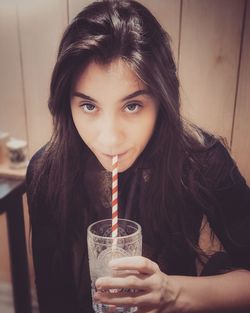 Portrait of woman drinking glass