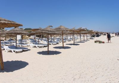 Scenic view of beach against blue sky