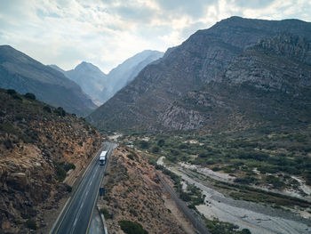 High angle view of road amidst mountains against sky