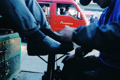 Low section of man sitting in bus