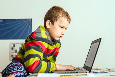 Cute boy looking at laptop