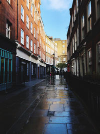 Street amidst buildings in city against sky