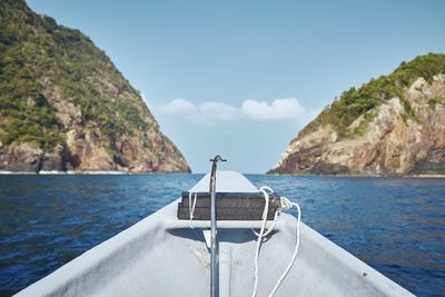 Scenic view of sea and mountains against sky