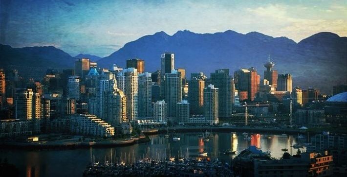 building exterior, architecture, city, built structure, cityscape, water, skyscraper, sky, mountain, reflection, waterfront, modern, river, illuminated, mountain range, cloud - sky, office building, tower, residential building, urban skyline