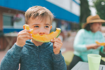 Portrait of boy eating food