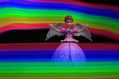 Digital composite image of woman with multi colored umbrella