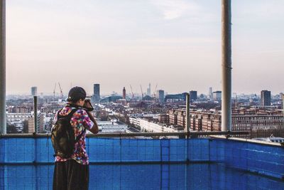 Rear view of woman standing in city