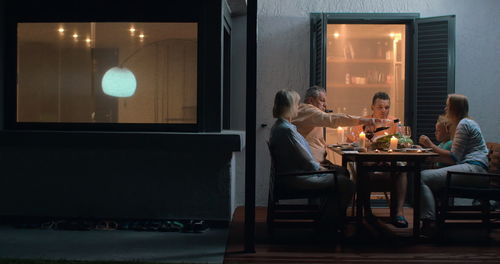 People sitting on table in illuminated room