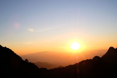 Scenic view of silhouette mountains against sky during sunset