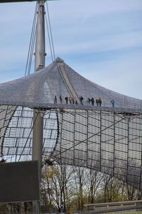 People on bridge against sky