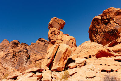 Low angle view of rocks against blue sky