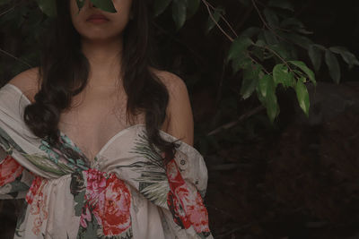 Midsection of woman standing by plants