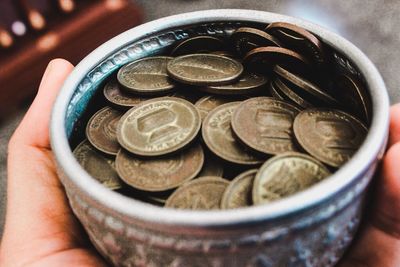 Close-up of hand holding coins