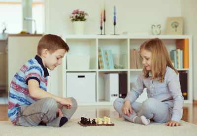 Siblings sitting at home