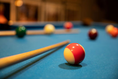 Macro shot of snooker, billiard balls, pool game table, cue ball, striped ball, pool stick