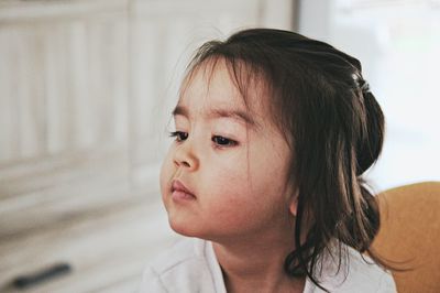 Close-up portrait of a girl looking away