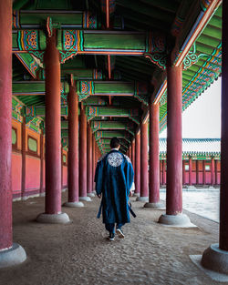 Korean man walking through the korean palace