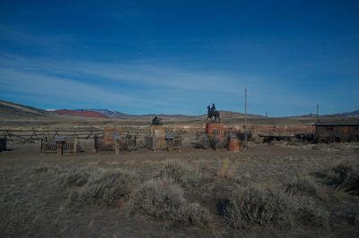 Scenic view of landscape against blue sky