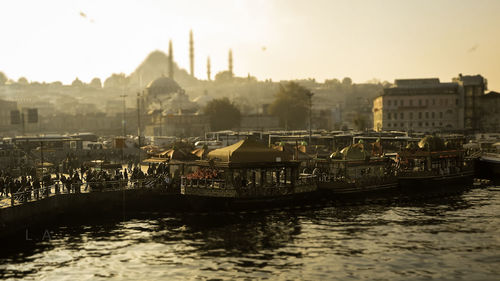 Boats moored on river by street