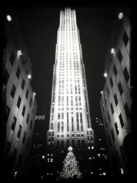 Low angle view of illuminated buildings against sky