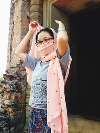 Low angle view of young woman visiting temple