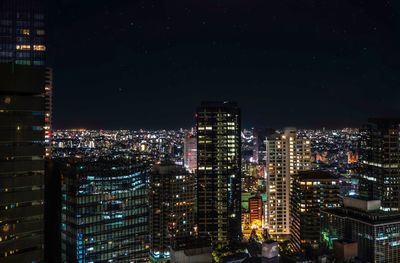 Illuminated buildings in city at night