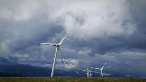 Windmill on field against sky