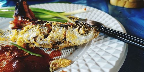 Fried fish, trout, on a white platter