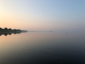 Scenic view of sea against clear sky during sunset