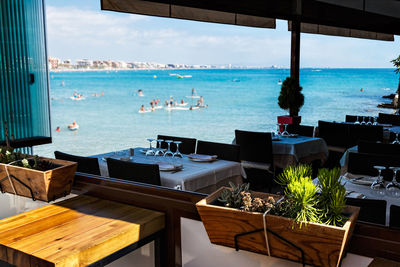 View of restaurant by sea against sky