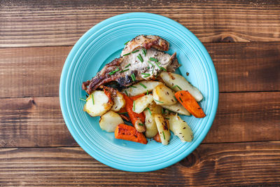 Close-up of food served in plate on wooden table