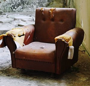 Old rusty chair against wall
