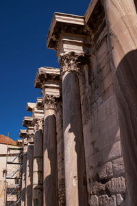 Low angle view of historical building against clear blue sky