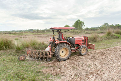 Tractor on field against sky