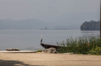 View of calm sea against mountain range