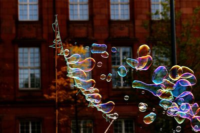 Close-up of bubbles against rainbow in building