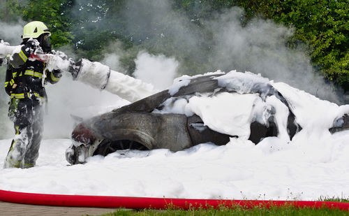 Fire on the car and firefighter