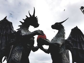 Low angle view of horse statue against sky