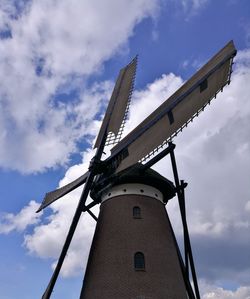 Low angle view of traditional windmill against sky