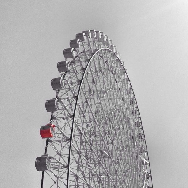 ferris wheel, low angle view, arts culture and entertainment, amusement park ride, amusement park, clear sky, built structure, architecture, copy space, building exterior, circle, sky, day, metal, outdoors, no people, pattern, tall - high, geometric shape, tower