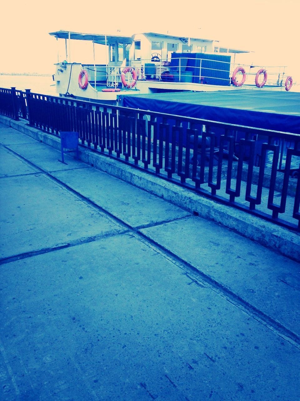 built structure, architecture, building exterior, empty, railing, in a row, absence, building, day, outdoors, no people, incidental people, city, transportation, sunlight, bench, residential building, chair, side by side, wood - material