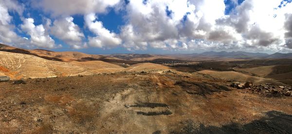 View of arid landscape against sky