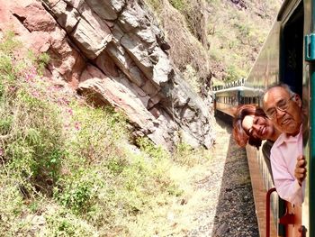 Portrait of people standing at doorway while traveling in train